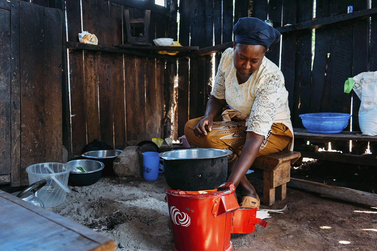 Cracking the code of carbon pricing_A community member cooking on an energy efficient cookstove_visual 3