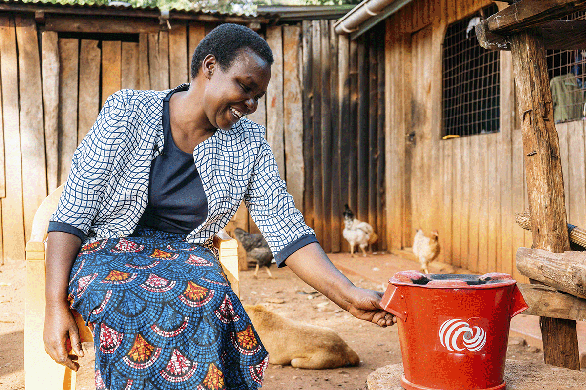 DGB Group CEO Selwyn Duijvestijn returns to Business Class_A community member with a DGB cooktove, Hongera Energy Efficient Cookstoves Project_visual 3