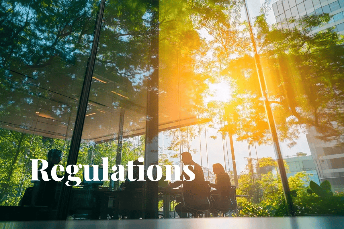 EU scales back corporate sustainability reporting, proposed changes_Modern glass office amid lush greenery, with workers inside_visual 1-1