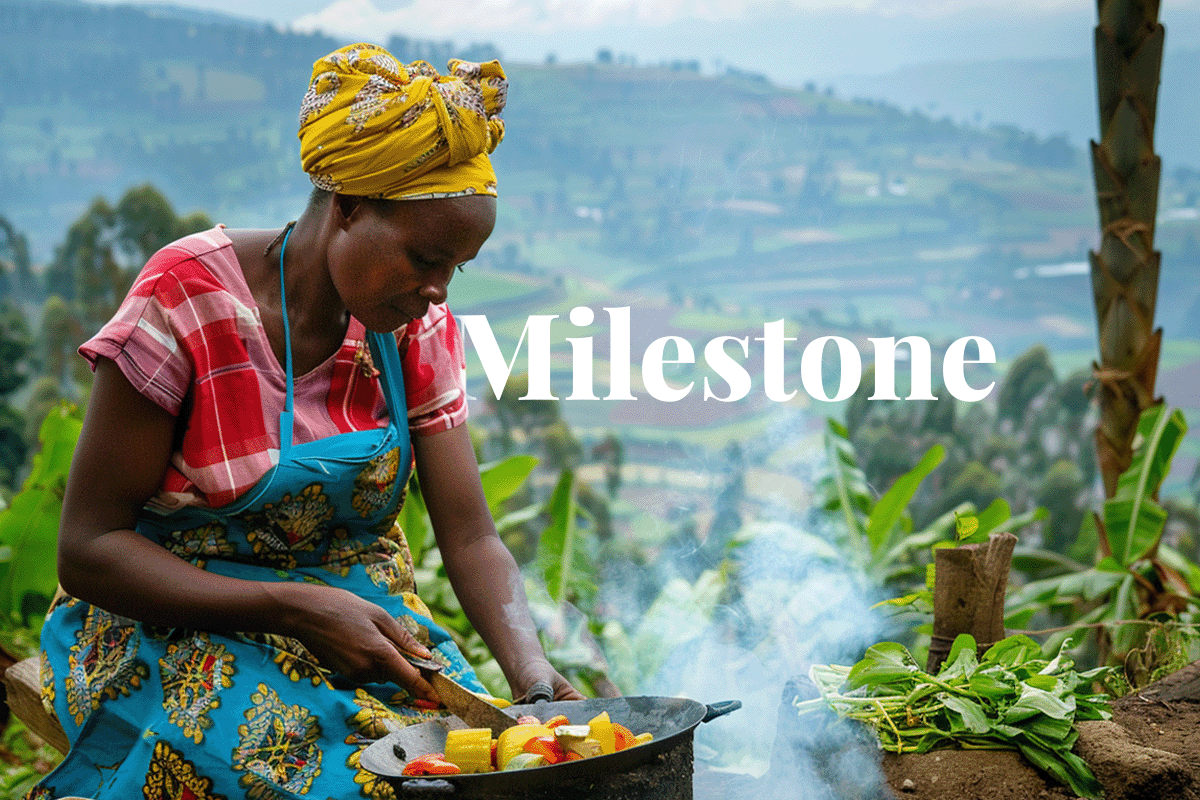 Industry milestone achieved with first Article 6 carbon credits_African woman preparing a meal using an energy efficient cookstove, Rwanda landscape in the background_visual 1