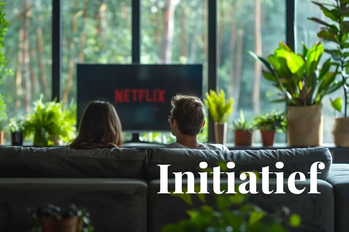 Netflix backs 15-year carbon credit deal to expand US reforestation_Two people watching TV in their apartment with a green forest outside the window_visual 1_NL