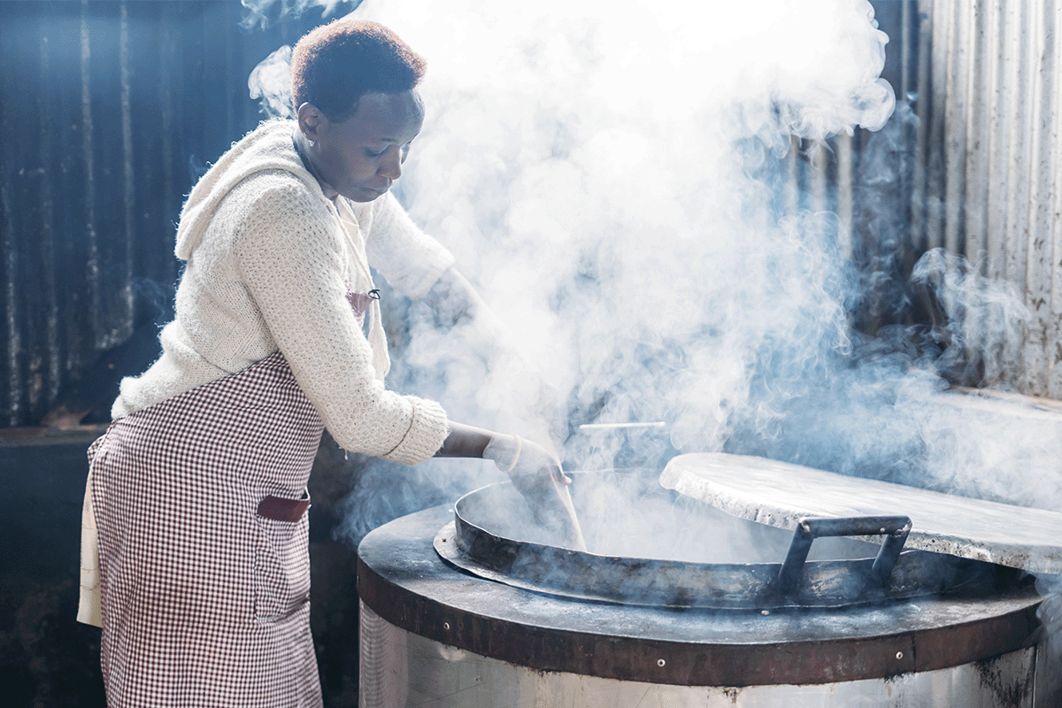 Sparking health and sustainability in Kenyas schools_A local woman cooking a meal for pupils_visual 2
