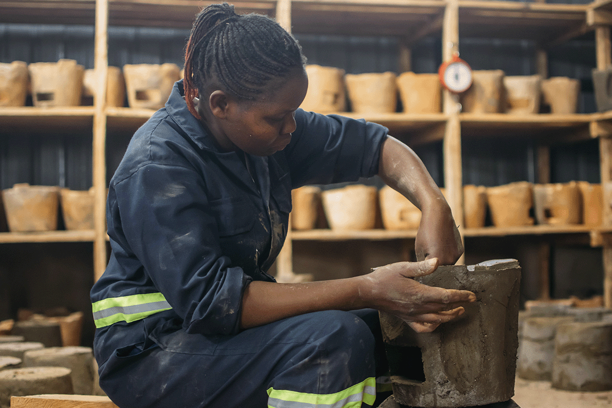The importance of carbon offsetting in achieving net zero_A local woman working in a cookstove factory_visual 6