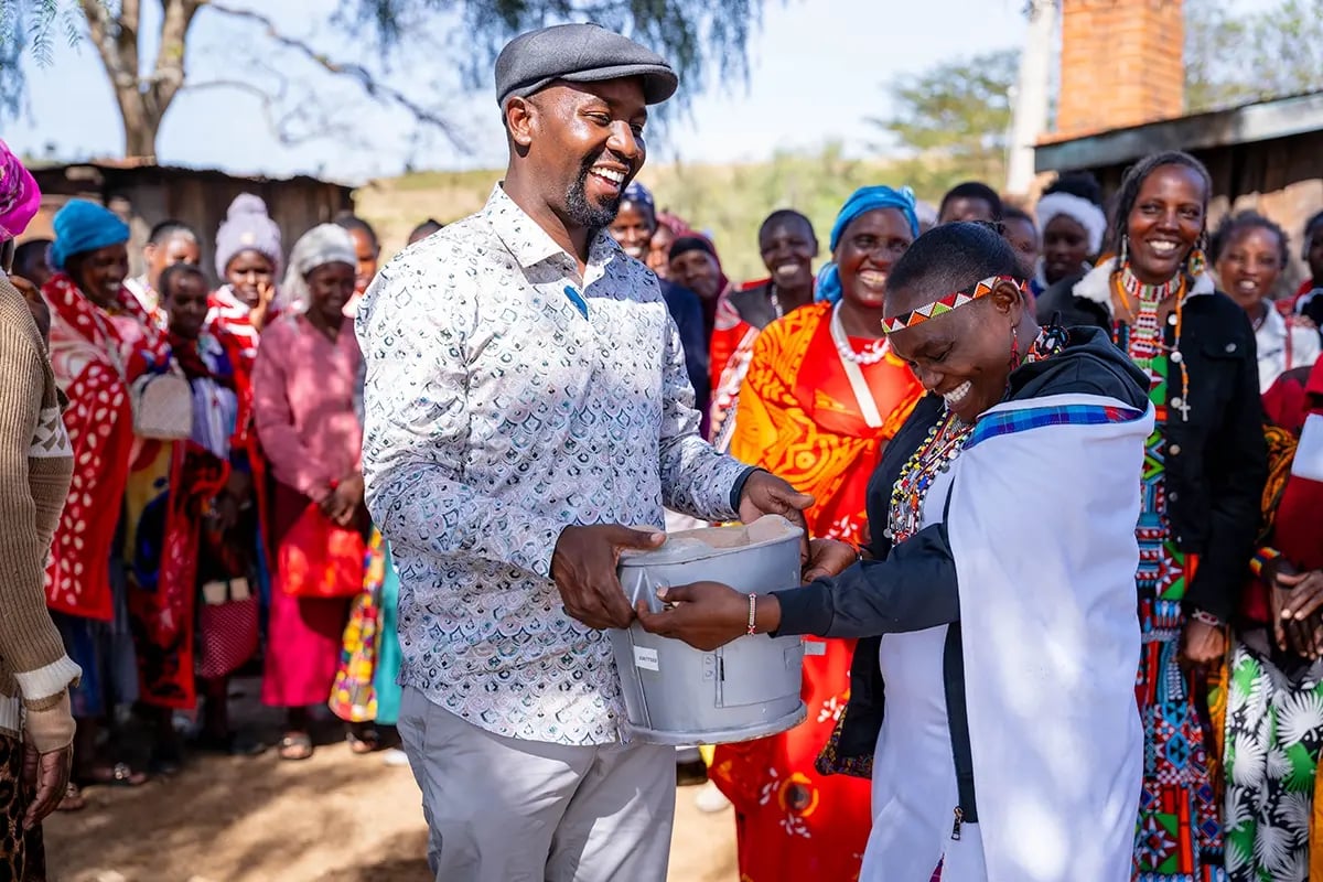 What are carbon credit funds_A DGB team member with the local community during the distribution of Energy efficient cookstoves_visual 6
