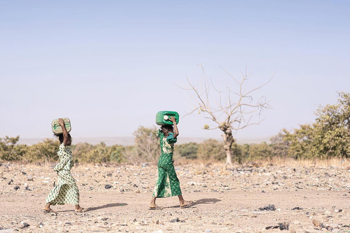  A group of women transporting drinking water to a village, Africa.